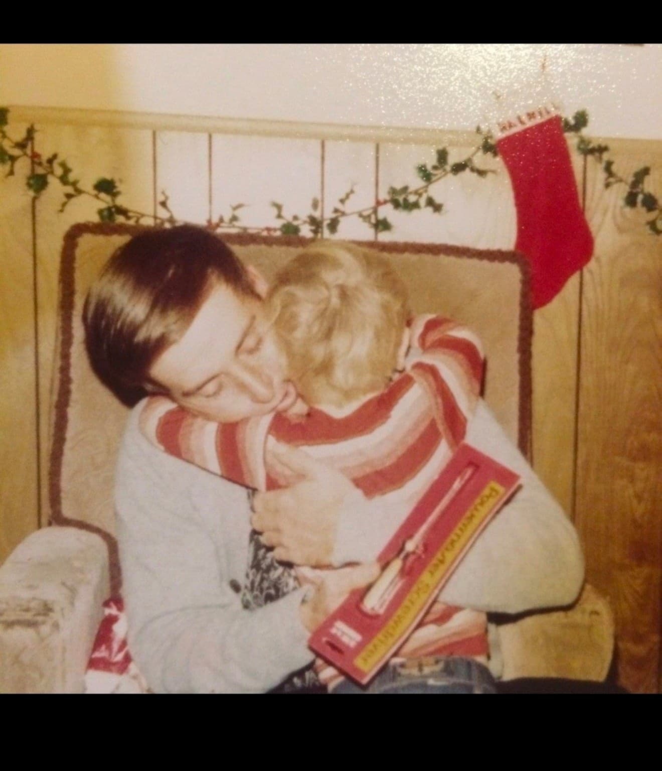 Tom Mitchell's father holding him as a child